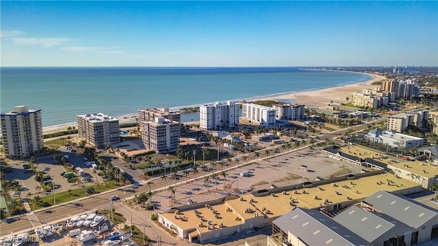 drone / aerial view featuring a water view and a view of the beach