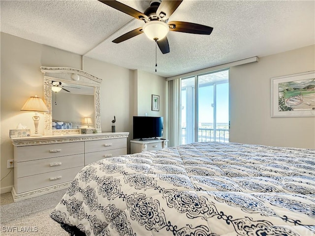 carpeted bedroom with ceiling fan, a textured ceiling, and access to outside