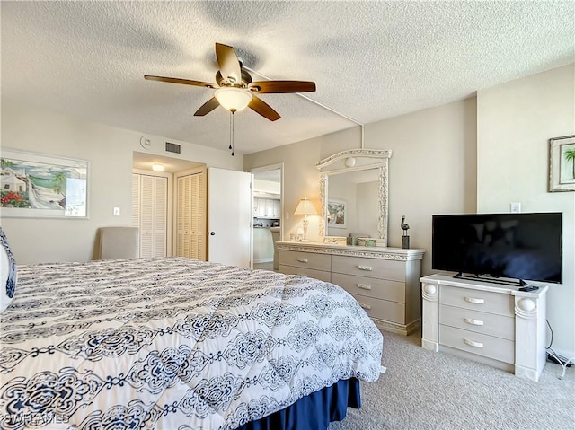 carpeted bedroom featuring a textured ceiling and ceiling fan