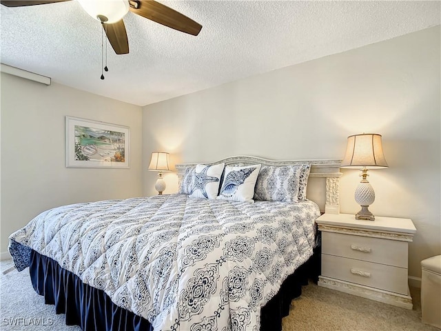 carpeted bedroom with a textured ceiling and ceiling fan