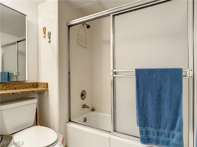 bathroom with bath / shower combo with glass door and toilet