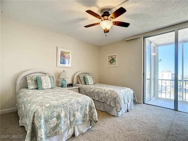 carpeted bedroom featuring access to exterior, a textured ceiling, and ceiling fan