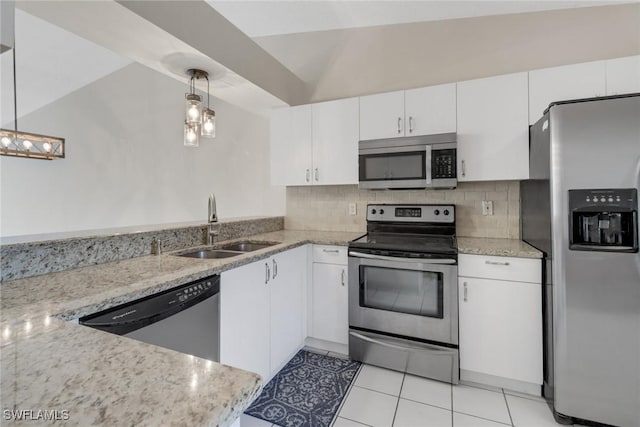 kitchen featuring decorative light fixtures, white cabinets, appliances with stainless steel finishes, and vaulted ceiling