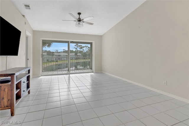 unfurnished living room featuring ceiling fan and light tile patterned floors