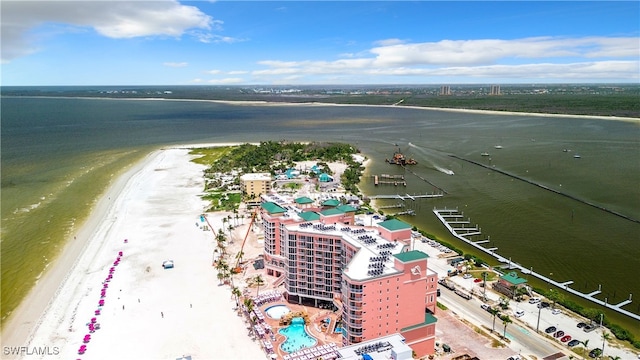 drone / aerial view with a water view and a beach view