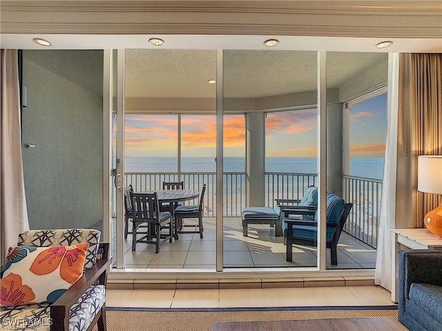 sunroom / solarium with a water view