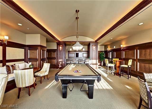 rec room with brick ceiling, light colored carpet, vaulted ceiling, and pool table