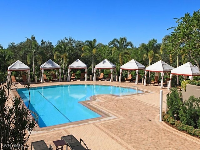 view of swimming pool featuring a gazebo and a patio area