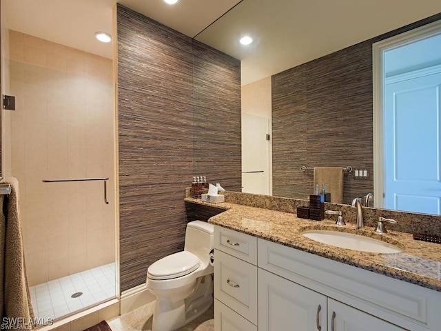 bathroom featuring an enclosed shower, vanity, and toilet