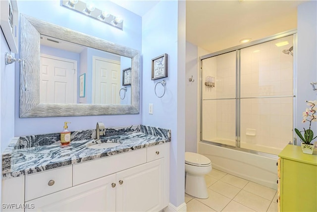 full bathroom featuring tile patterned floors, vanity, toilet, and combined bath / shower with glass door