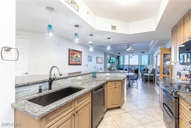 kitchen with ceiling fan, sink, light stone counters, pendant lighting, and black appliances