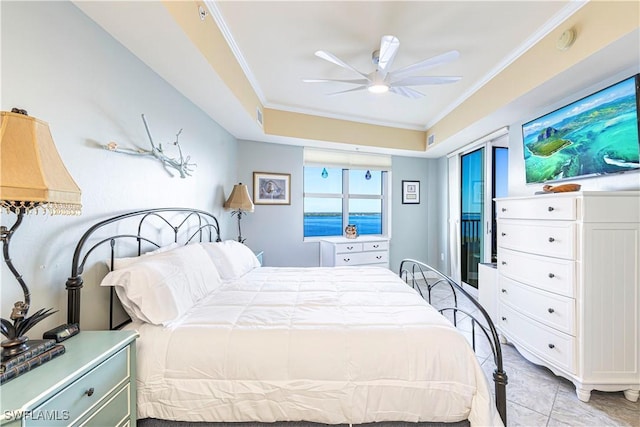 bedroom with a raised ceiling, ceiling fan, light tile patterned floors, and ornamental molding