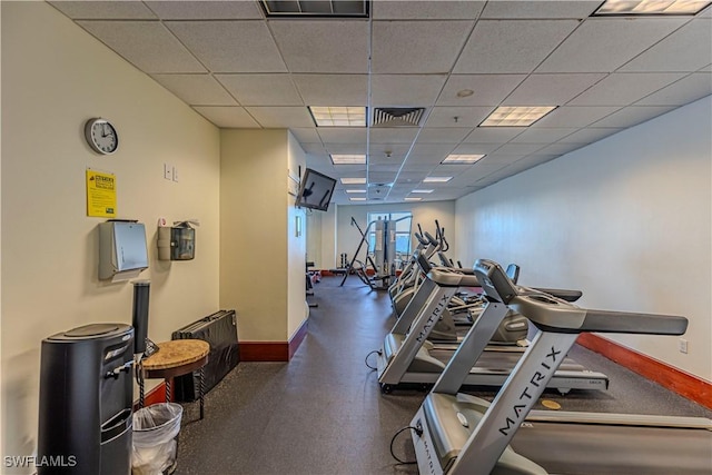 exercise room featuring a paneled ceiling