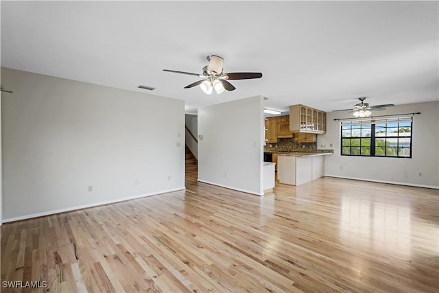 unfurnished living room with light hardwood / wood-style floors and ceiling fan