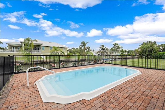 view of swimming pool with a water view and a patio area