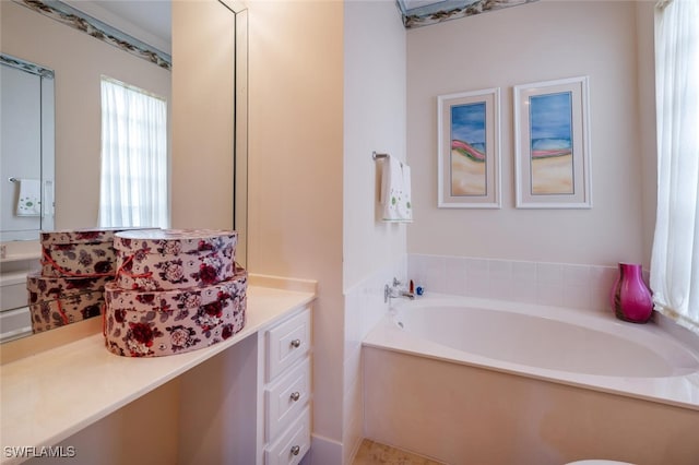 bathroom featuring vanity and a tub to relax in