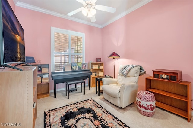 sitting room with crown molding, ceiling fan, and light colored carpet