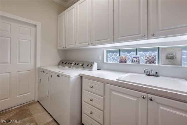 laundry area with cabinets, sink, and washing machine and clothes dryer