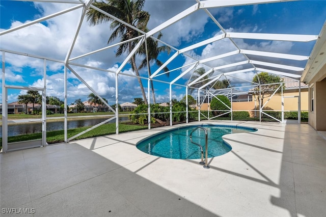 view of pool with a lanai, a patio area, and a water view