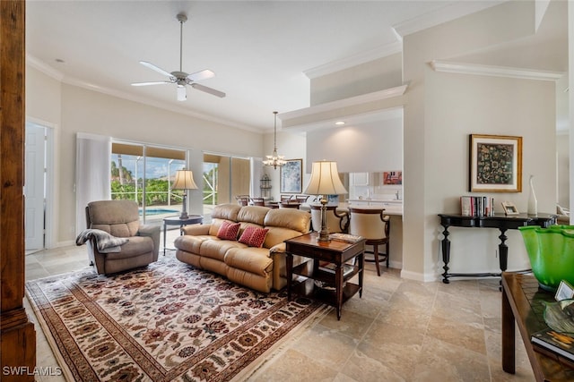 living room with a towering ceiling, ceiling fan with notable chandelier, and ornamental molding