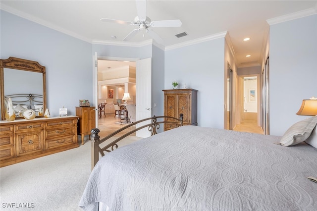 carpeted bedroom featuring connected bathroom, ceiling fan, and ornamental molding