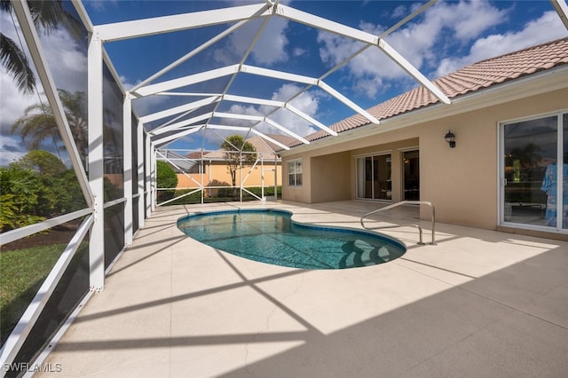 view of swimming pool featuring glass enclosure and a patio