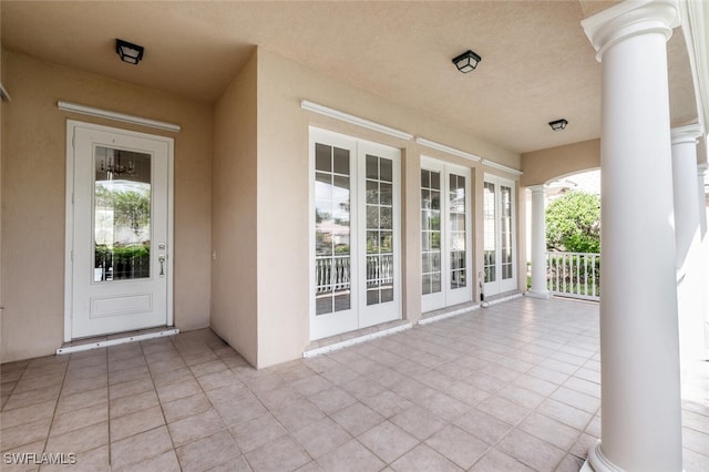 view of exterior entry with covered porch