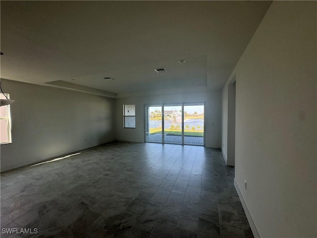 empty room with a raised ceiling