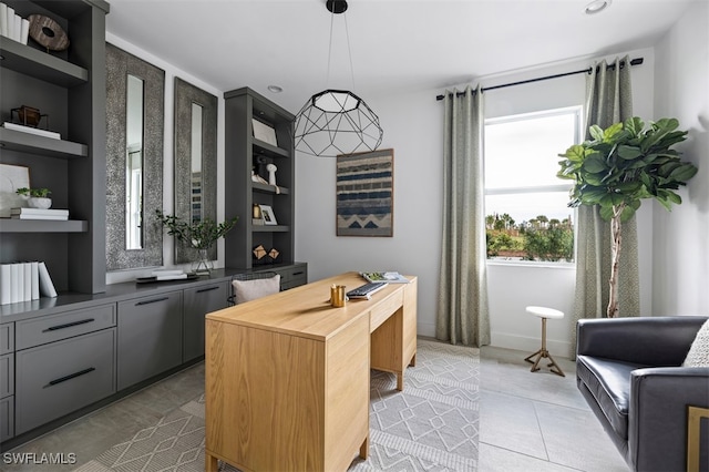 office space featuring built in features and light tile patterned floors