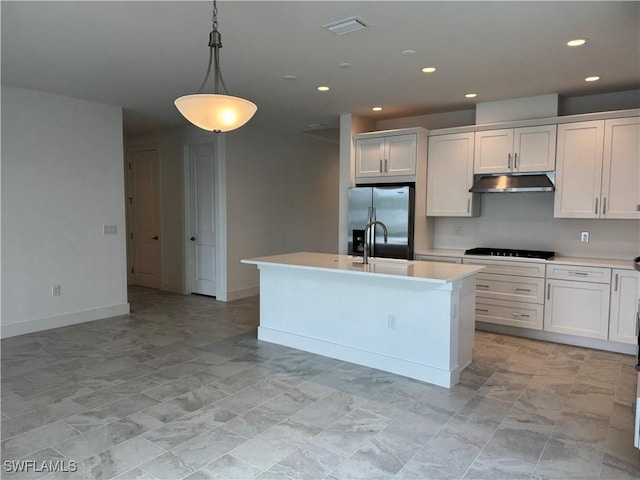 kitchen featuring under cabinet range hood, black cooktop, a sink, light countertops, and stainless steel refrigerator with ice dispenser