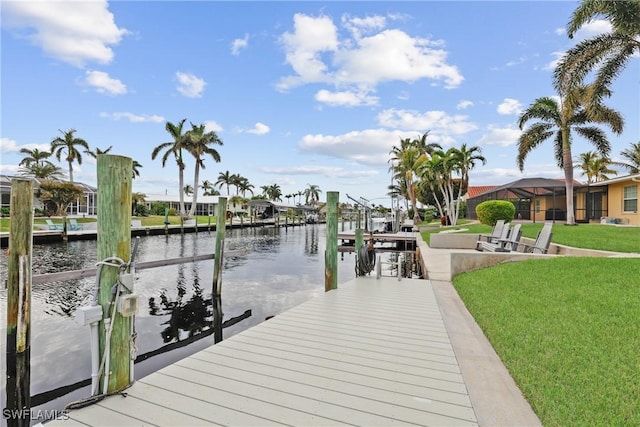 dock area with a water view and a yard