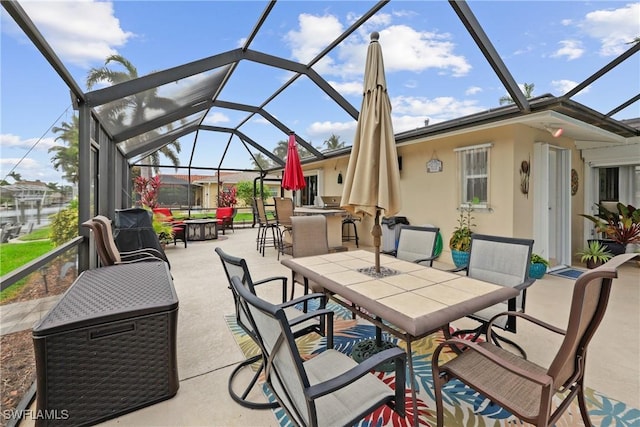 view of patio / terrace featuring glass enclosure and an outdoor bar