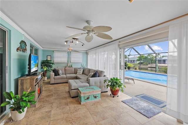 sunroom / solarium with ceiling fan and a swimming pool