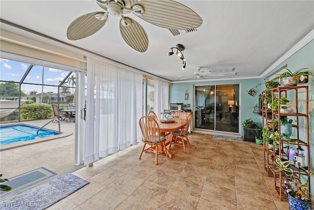 sunroom / solarium with ceiling fan and a swimming pool