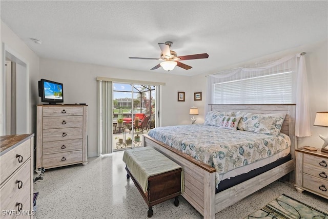 bedroom with access to exterior, ceiling fan, and a textured ceiling