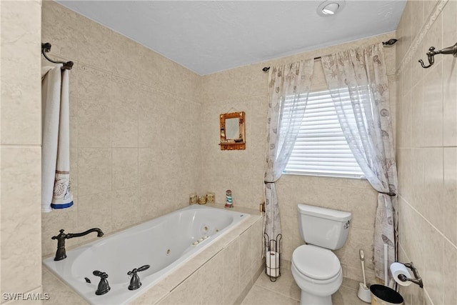 bathroom with tile patterned flooring, a relaxing tiled tub, and toilet