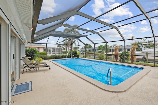 view of pool with a lanai and a patio