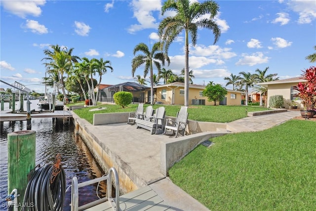 surrounding community with a lawn, a dock, and a water view