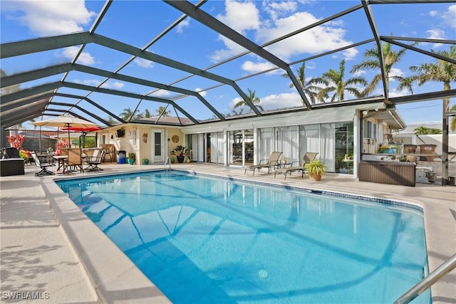 view of swimming pool featuring a patio and glass enclosure