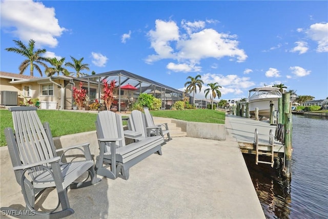 view of patio / terrace featuring a lanai, a water view, and a dock