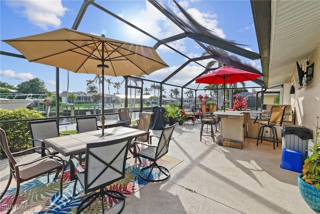 view of patio with a bar and a lanai