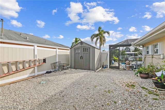 view of yard with a lanai and a storage shed