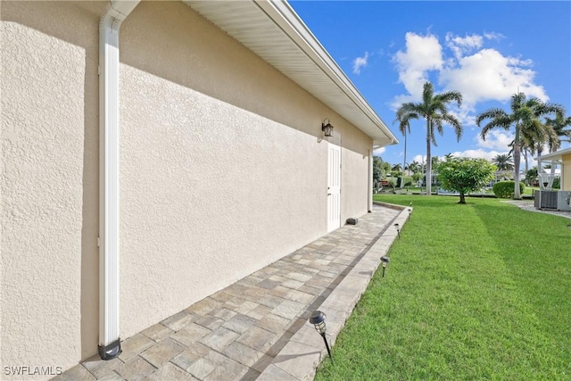 view of home's exterior featuring a yard and cooling unit