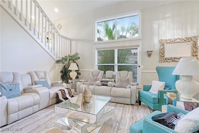 living room featuring a towering ceiling