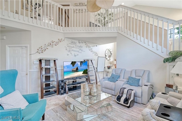 living room with ceiling fan and high vaulted ceiling