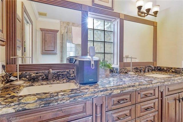 bathroom featuring ornamental molding, vanity, a shower with shower door, and a notable chandelier