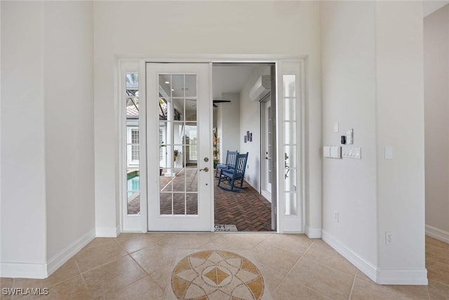 entryway with french doors and light tile patterned floors