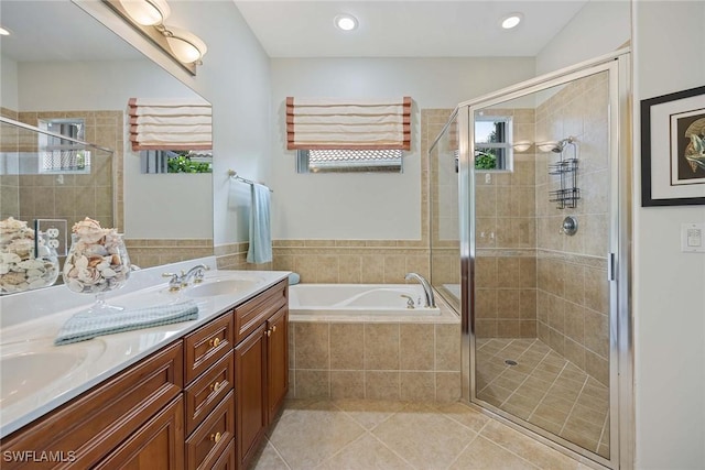 bathroom with tile patterned floors, plus walk in shower, and vanity