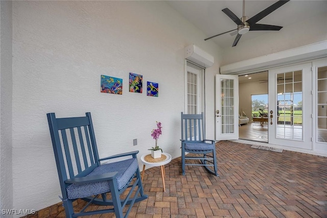 view of patio featuring ceiling fan, french doors, and a wall mounted air conditioner