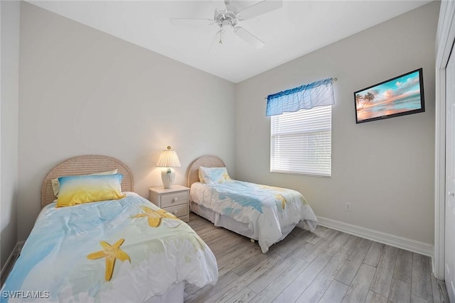 bedroom with light wood-type flooring and ceiling fan